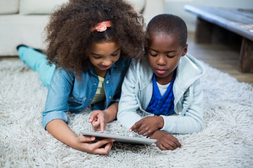 Children using digital tablet at home